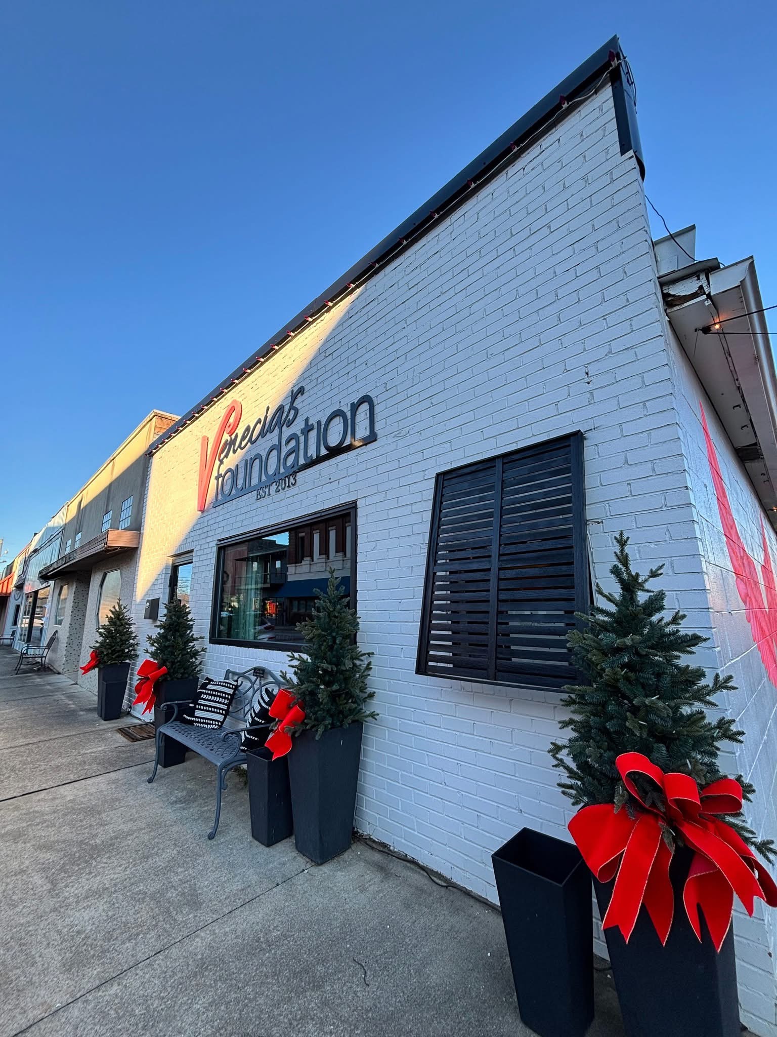 White building storefront with holiday decor